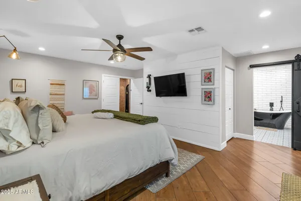 a bedroom with a bed and a flat screen tv