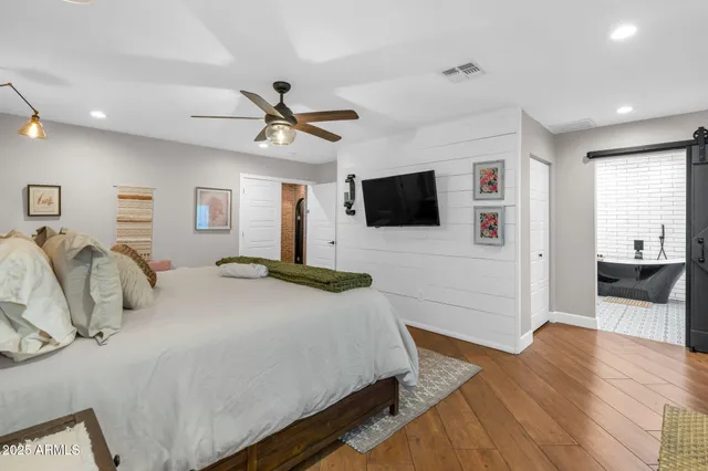 a bedroom with a bed and a flat screen tv