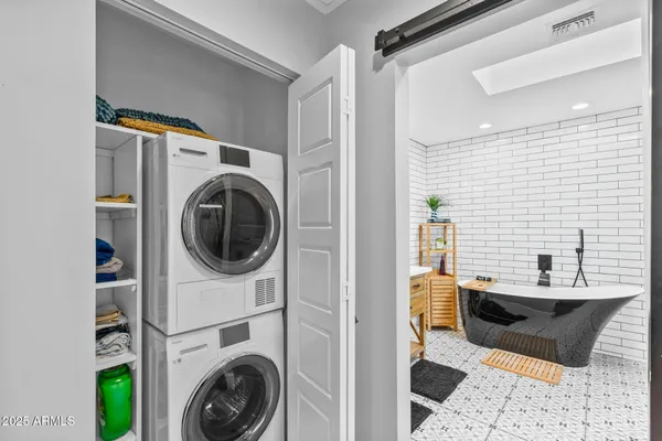 a bathroom with a sink a washer and dryer