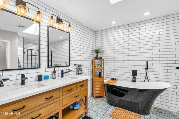 a bathroom with double vanity sink and a mirror