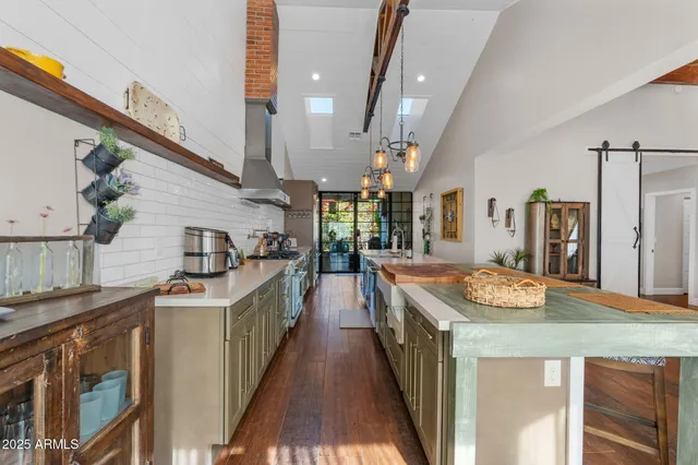 a kitchen with stainless steel appliances granite countertop a sink and a refrigerator