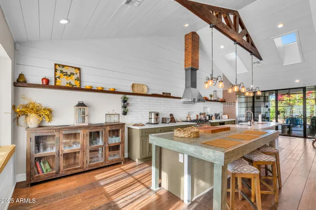 a open kitchen with stainless steel appliances granite countertop a stove and a refrigerator