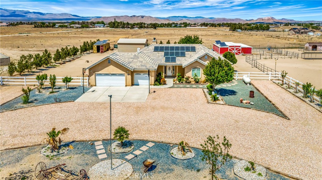 an aerial view of a house with a yard lake view and mountain view