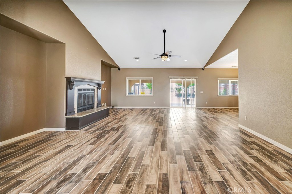 7315 West Ave A 8 Lancaster, CA 93536 - Photo 11 of 65 a view of empty room with wooden floor and fan