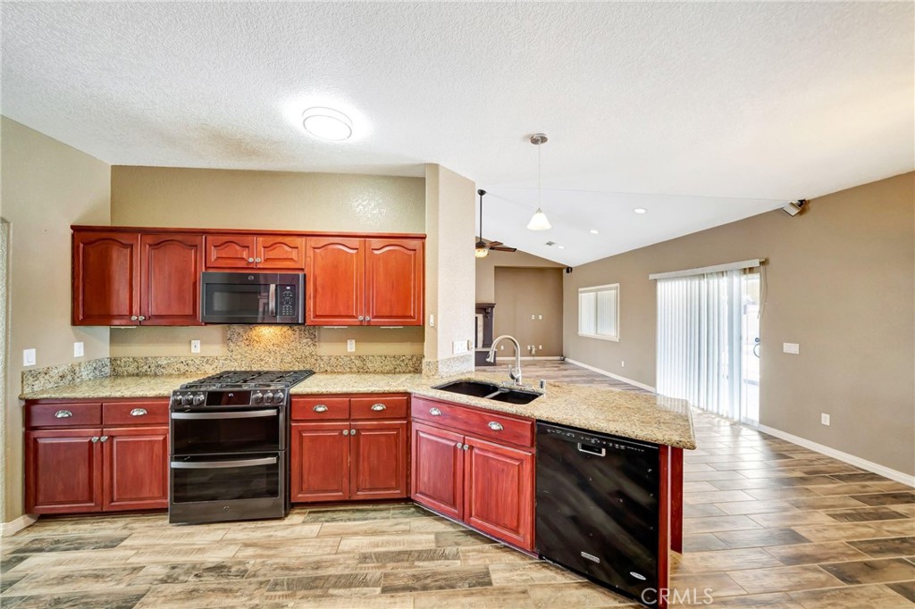7315 West Ave A 8 Lancaster, CA 93536 - Photo 16 of 65 a kitchen with stainless steel appliances granite countertop a stove a sink and a microwave
