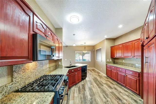 a view of a livingroom with wooden floor and a window