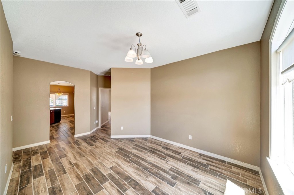 7315 West Ave A 8 Lancaster, CA 93536 - Photo 18 of 65 a view of a livingroom with wooden floor and a window