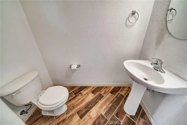 a bathroom with a granite countertop toilet and a shower