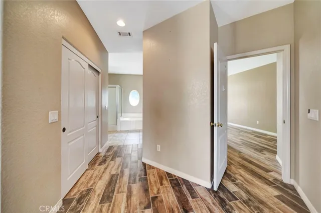 a spacious bathroom with a tub sink and mirror
