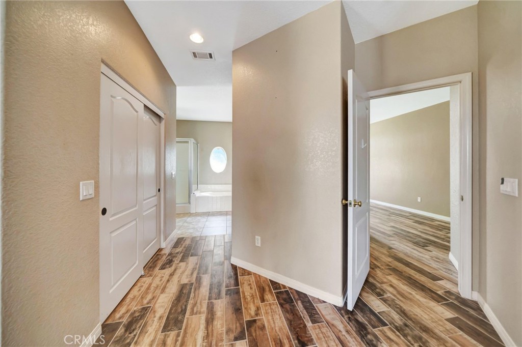 7315 West Ave A 8 Lancaster, CA 93536 - Photo 27 of 65 a view of a hallway with wooden floor and staircase