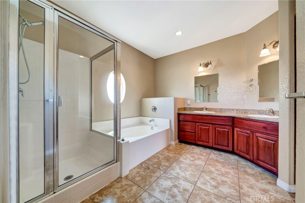 7315 West Ave A 8 Lancaster, CA 93536 - Photo 28 of 65 a spacious bathroom with a tub sink and mirror