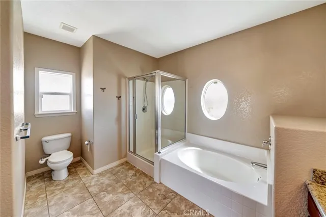 a spacious bathroom with a tub sink and mirror