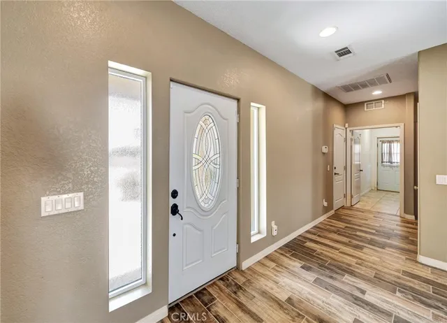 a view of a hallway with a livingroom and a bathroom