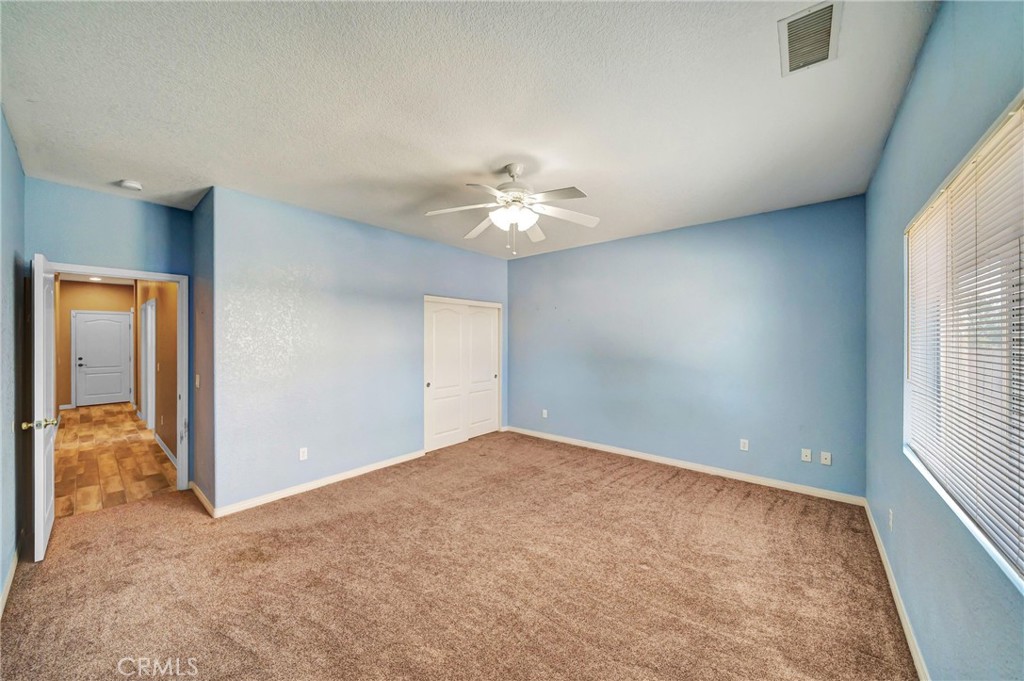 7315 West Ave A 8 Lancaster, CA 93536 - Photo 36 of 65 an empty room with windows and ceiling fan