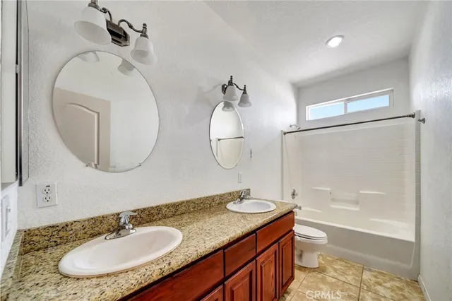 a room with granite countertop stainless steel appliances a sink and cabinets