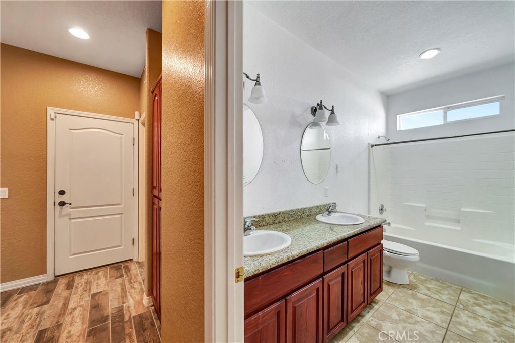 7315 West Ave A 8 Lancaster, CA 93536 - Photo 38 of 65 a bathroom with a granite countertop sink a toilet and shower