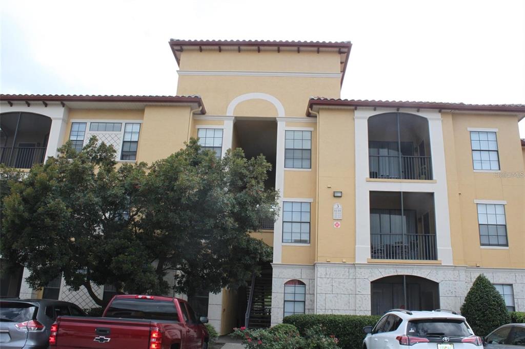 6159 Metrowest Boulevard, Unit 101 Orlando, FL 32835 - Photo 1 of 6 a front view of a house with parking space