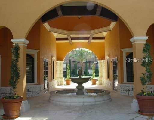 6159 Metrowest Boulevard, Unit 101 Orlando, FL 32835 - Photo 4 of 6 a living room with fireplace furniture and a potted plant