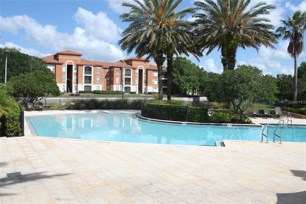 6159 Metrowest Boulevard, Unit 101 Orlando, FL 32835 - Photo 6 of 6 a view of a house with a swimming pool and a chair
