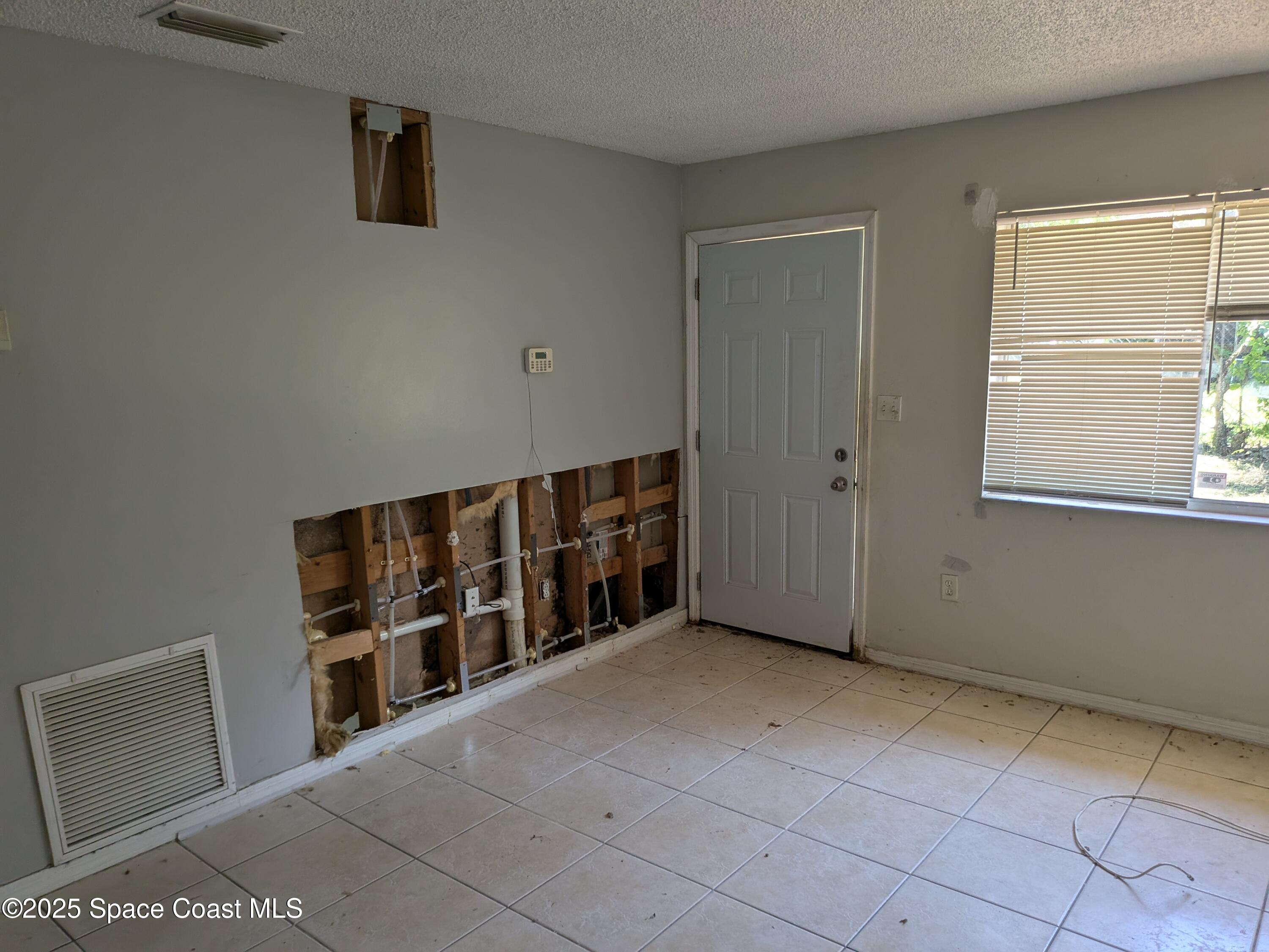 553 Rock Pit Road Titusville, FL 32796 - Photo 3 of 14 a view of an empty room with a window