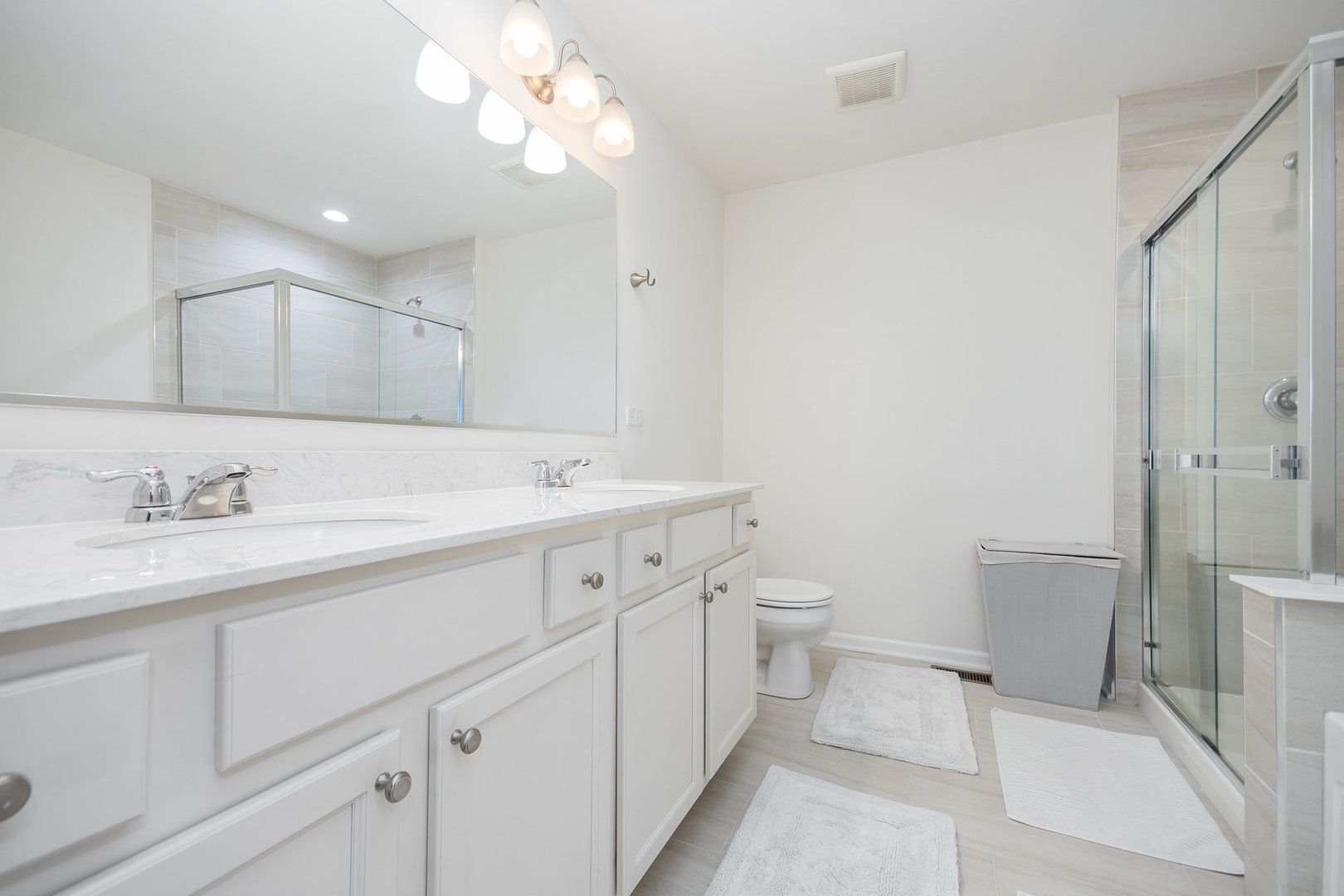 4166 Calder Lane Aurora, IL 60504 - Photo 14 of 30 a spacious bathroom with a double vanity sink mirror and toilet