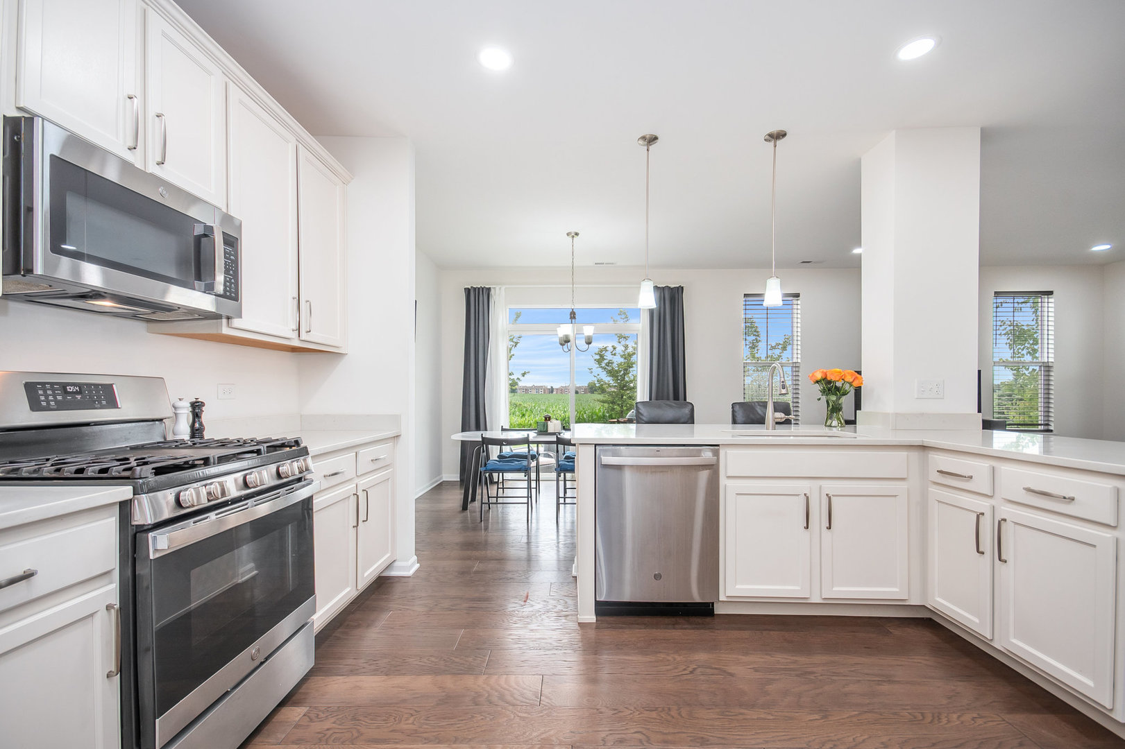 4166 Calder Lane Aurora, IL 60504 - Photo 7 of 30 a kitchen with stainless steel appliances a stove a sink and white cabinets