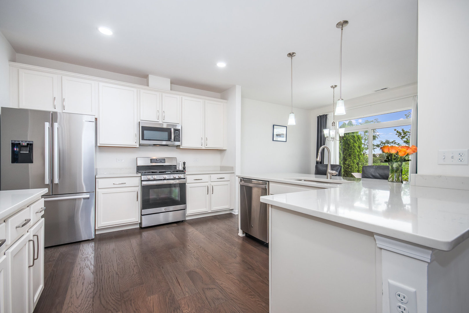 4166 Calder Lane Aurora, IL 60504 - Photo 8 of 30 a kitchen with a center island wooden floor stainless steel appliances and cabinets