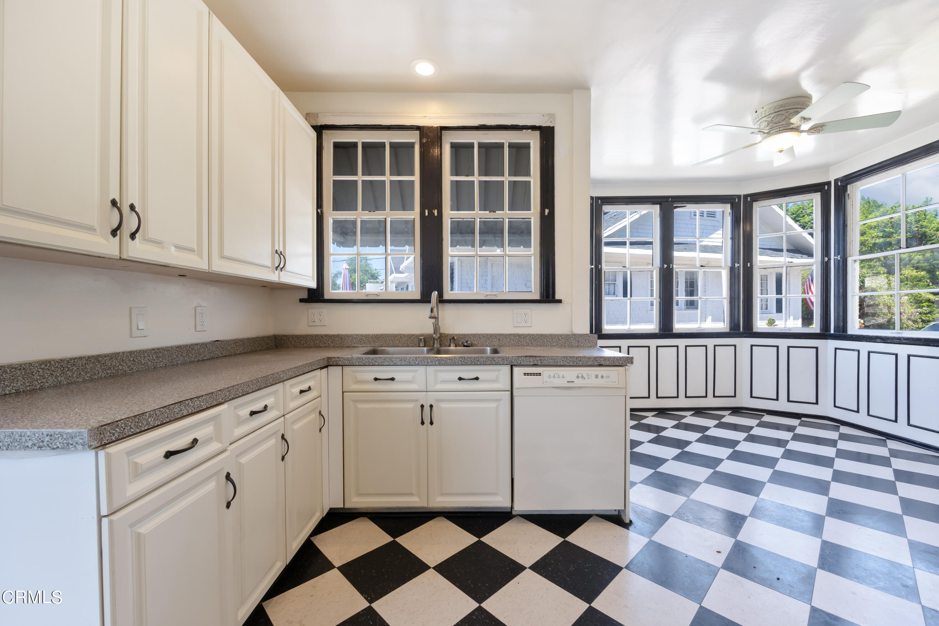 430 West Kenneth Road Glendale, CA 91202 - Photo 23 of 73 a kitchen with a checkered floor and white cabinets