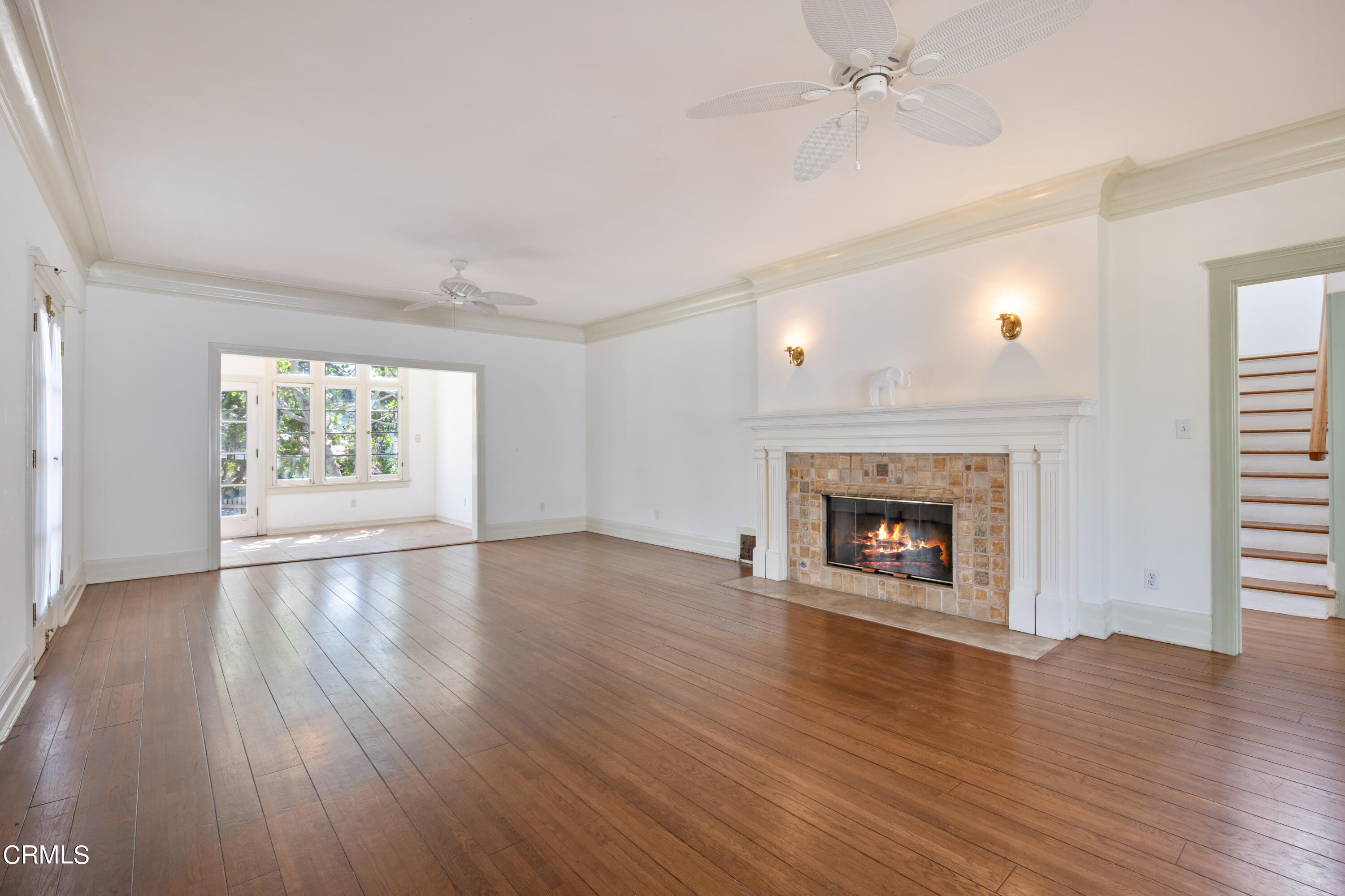 430 West Kenneth Road Glendale, CA 91202 - Photo 6 of 73 an empty room with large windows fireplace and wooden floor
