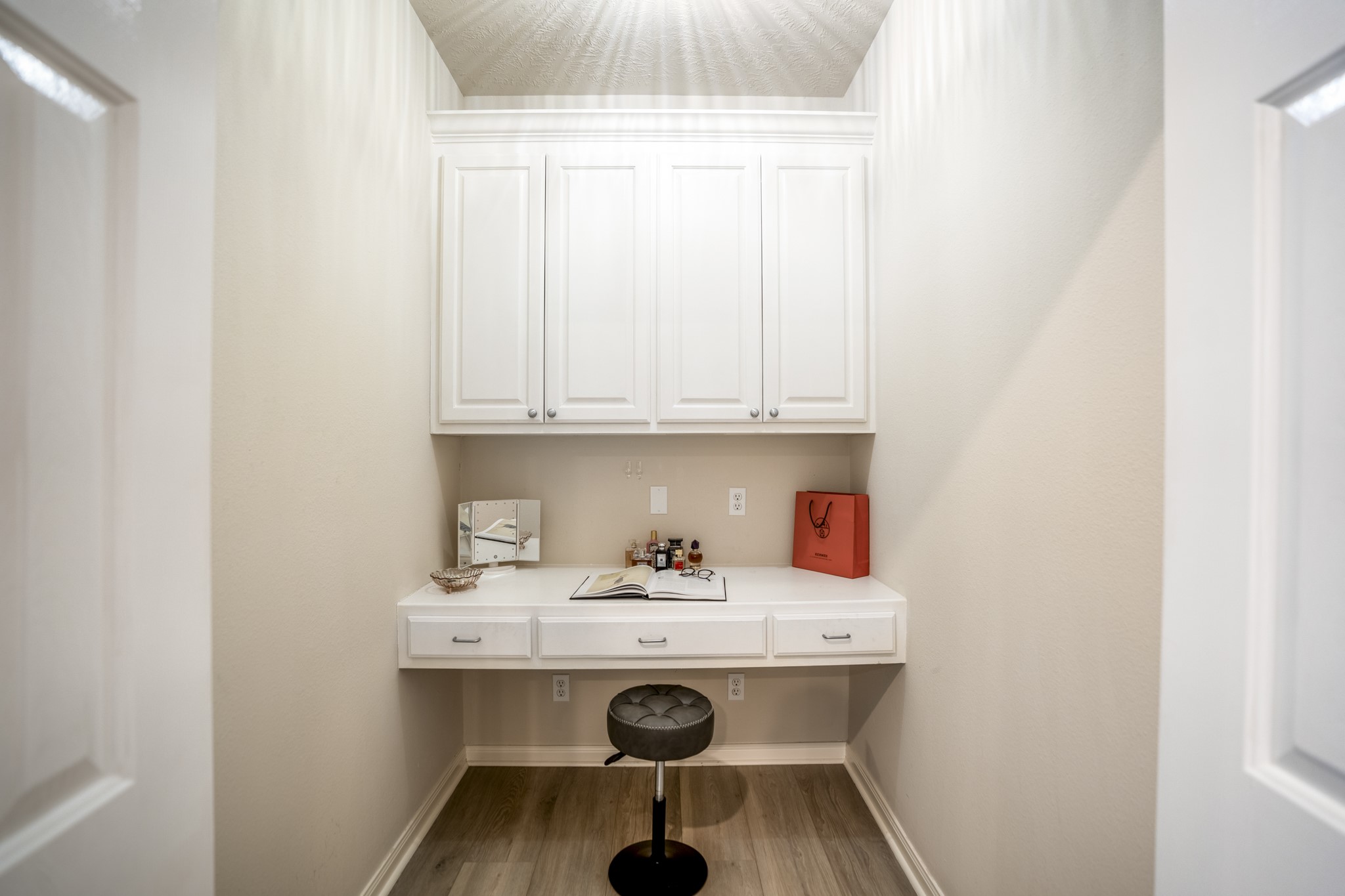 4236 Drake Street Houston, TX 77005 - Photo 18 of 43 A dedicated nook within the primary suite, currently utilized as a vanity, offers the perfect spot to get ready each day, and easily doubles as a convenient home office or quiet workspace.