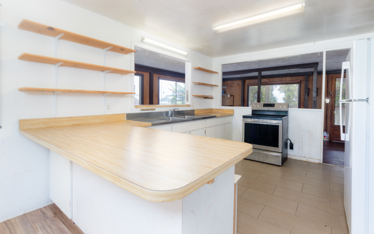 17-251 Volcano Road Keaau, HI 96749 - Photo 7 of 28 a kitchen with a sink a stove and chairs