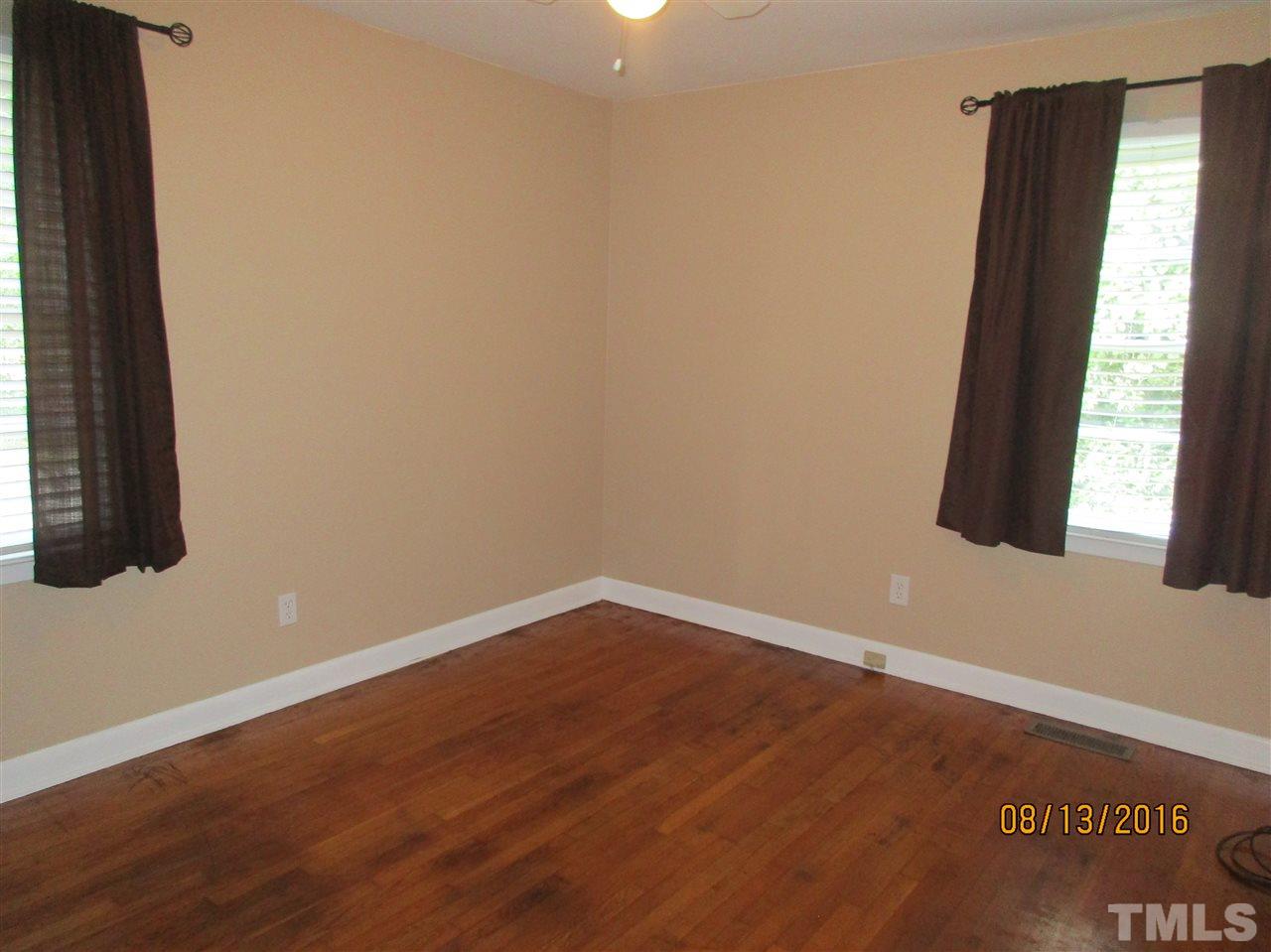 1642 Bickett Boulevard Raleigh, NC 27608 - Photo 14 of 25 an empty room with wooden floor and windows