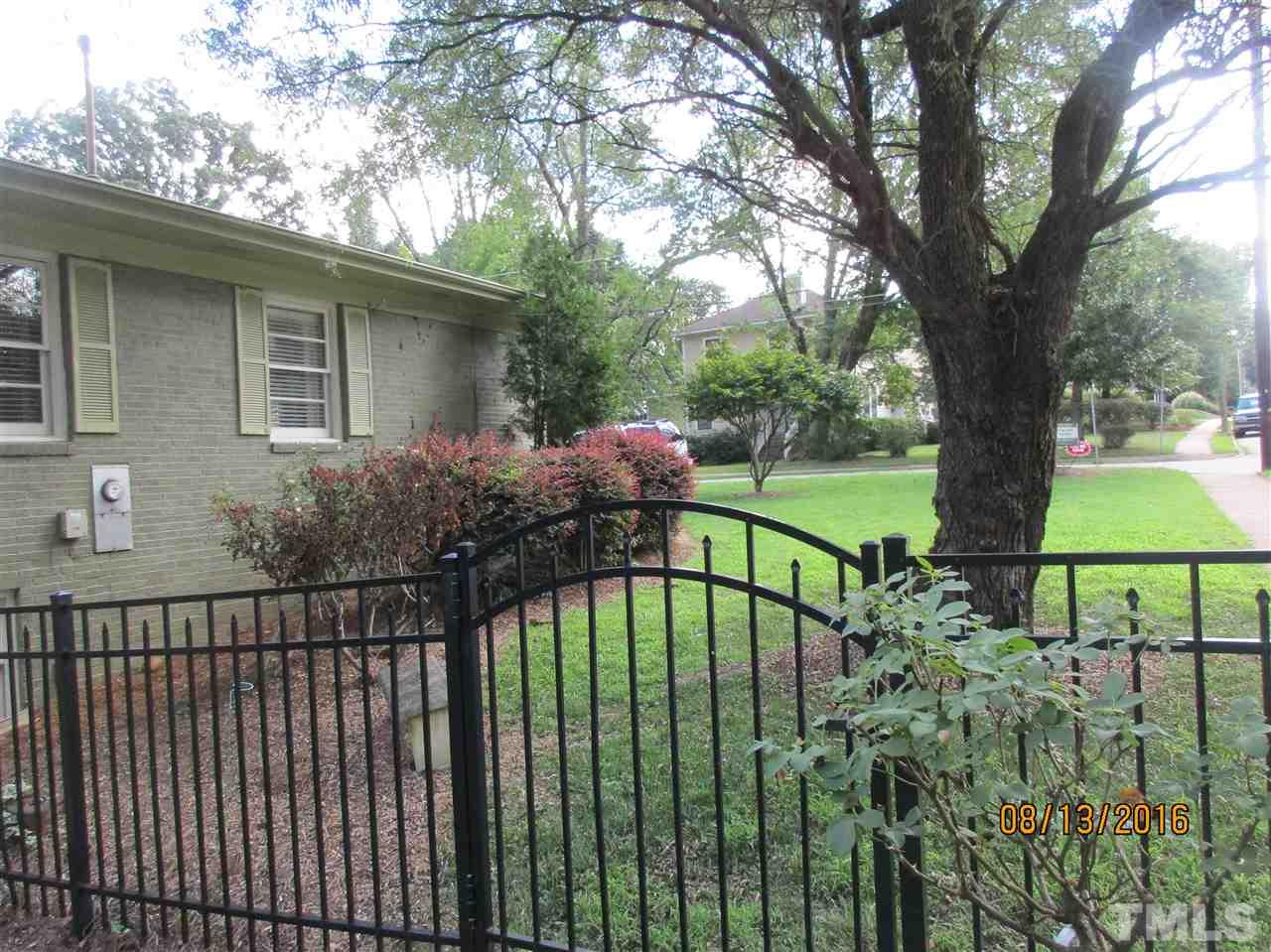 1642 Bickett Boulevard Raleigh, NC 27608 - Photo 22 of 25 a view of a house with a small yard and a large tree