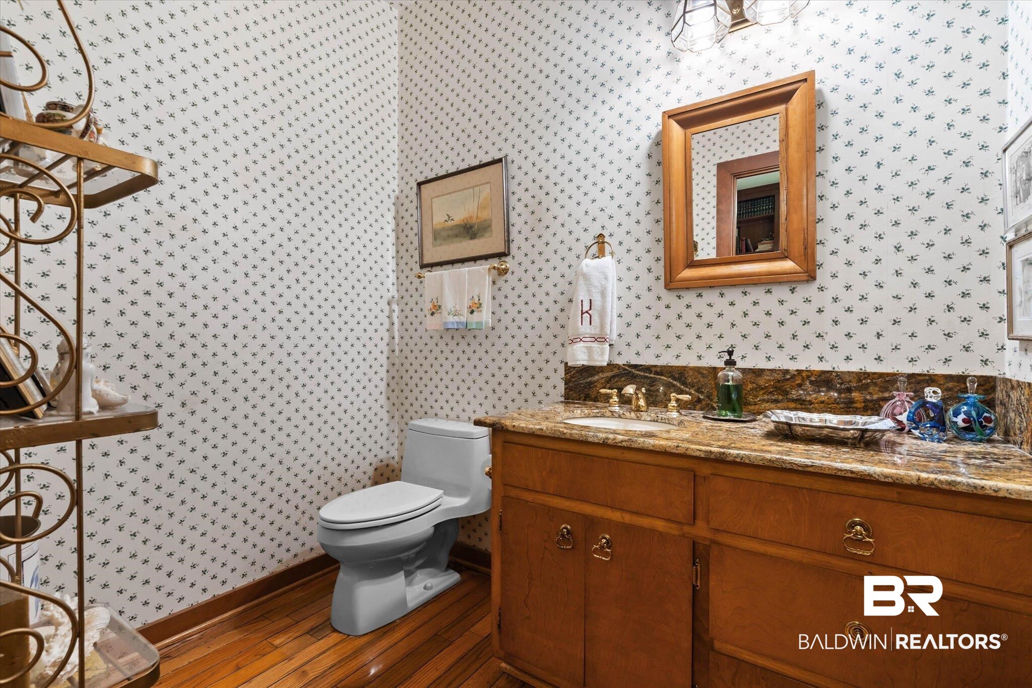 3500 Venetia Road Mobile, AL 36605 - Photo 11 of 56 Vanity with a polished stone countertop, undermount sink, and brass-finish faucet