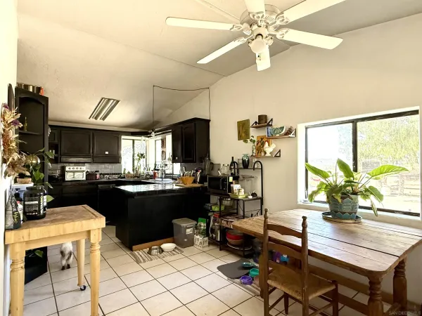 a kitchen with a table chairs and microwave