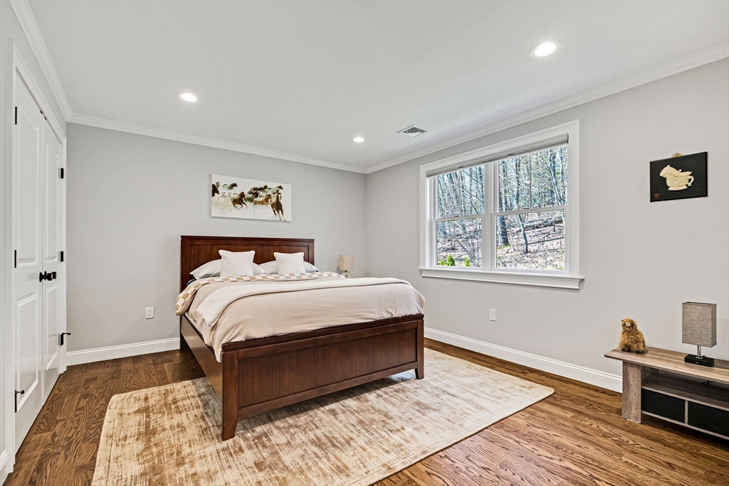 17 Sunrise Terrace Needham, MA 02492 - Photo 20 of 42 a bedroom with a bed and wooden floor