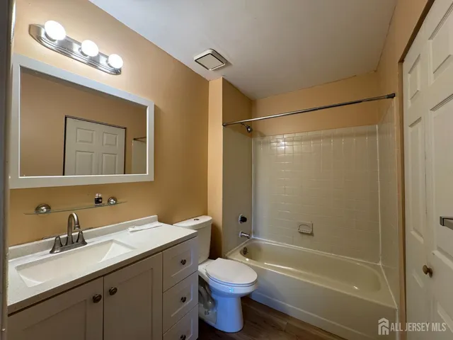 a bathroom with a sink toilet tub and shower