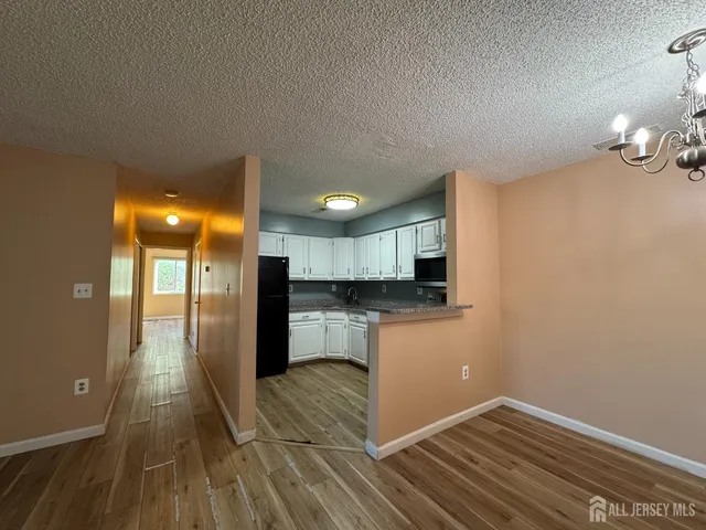 a view of a kitchen from the hallway