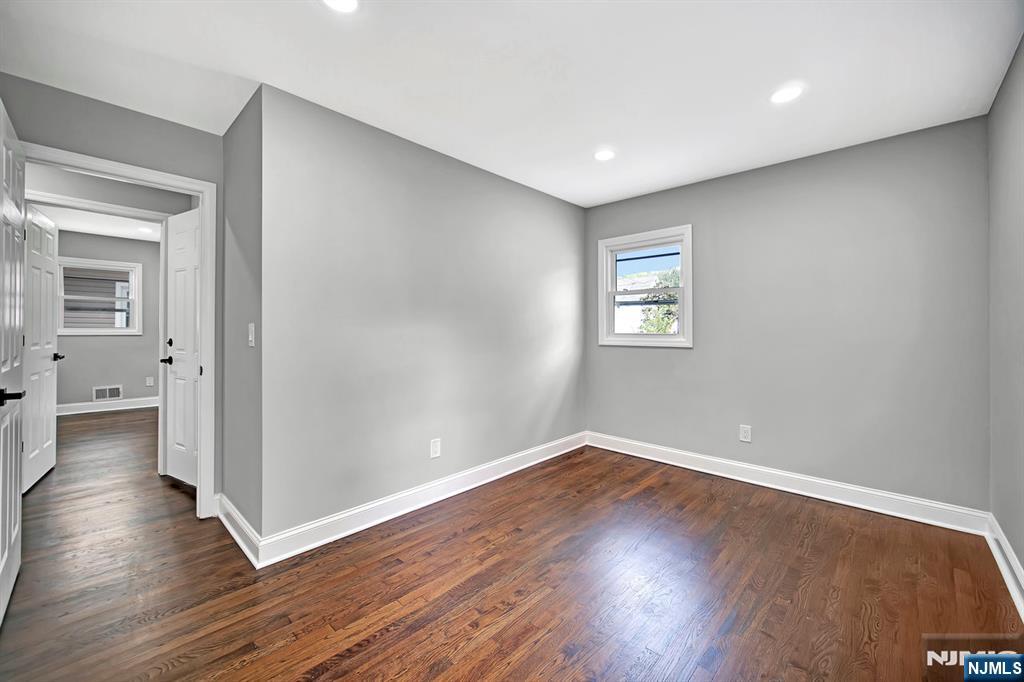 509 Grove Street Bloomfield, NJ 07017 - Photo 12 of 29 a view of an empty room with wooden floor and a window
