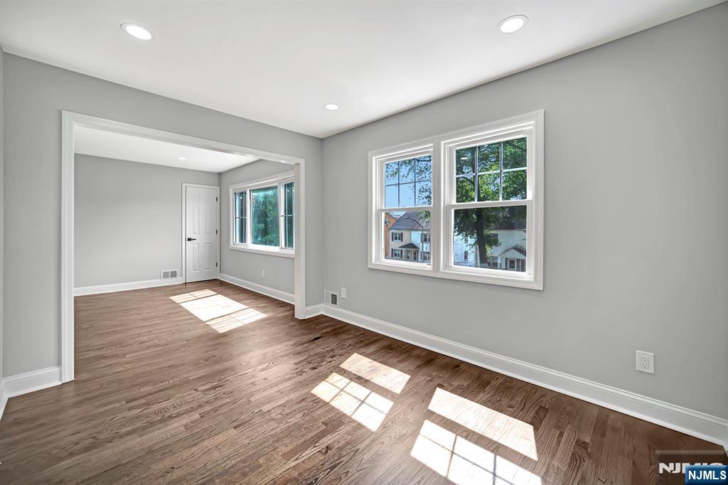 509 Grove Street Bloomfield, NJ 07017 - Photo 16 of 29 a view of empty room with wooden floor and fan