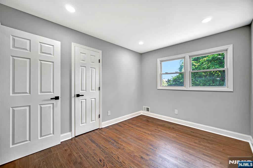 509 Grove Street Bloomfield, NJ 07017 - Photo 19 of 29 a view of empty room with wooden floor and fan