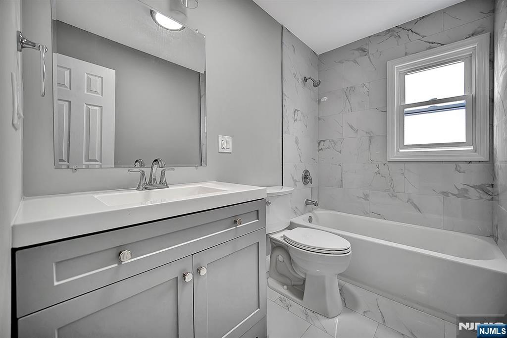 509 Grove Street Bloomfield, NJ 07017 - Photo 21 of 29 a bathroom with a sink a toilet and a bathtub