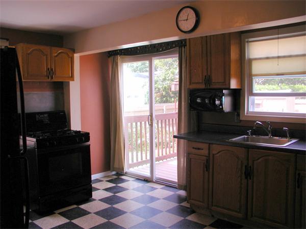 120 Merida Street Springfield, MA 01104 - Photo 7 of 24 a kitchen with a sink a refrigerator and a stove top oven