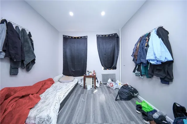 a bed room with a bed window and a chair