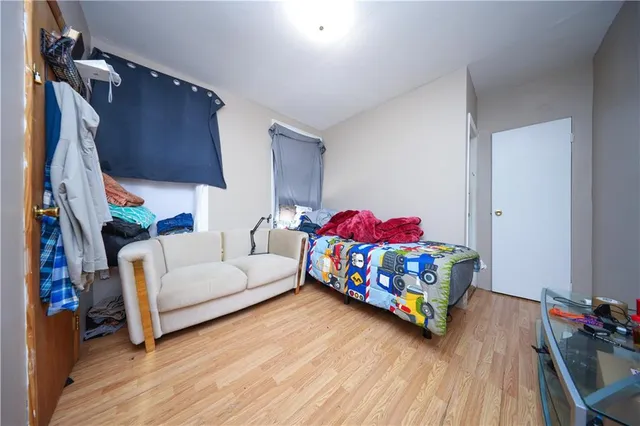 a bedroom with a bed and a couch