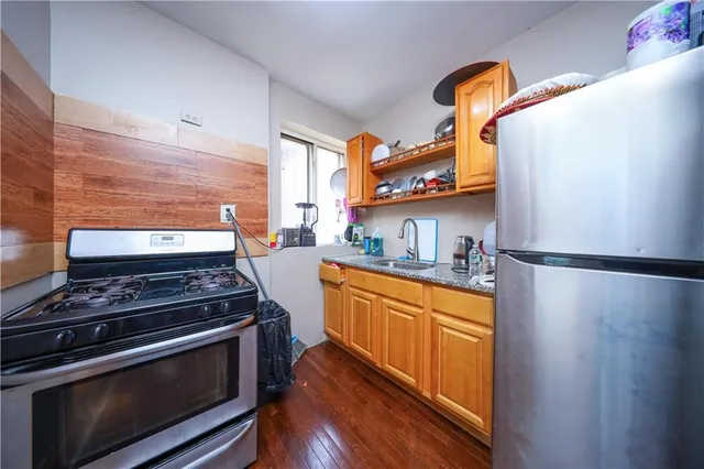 a kitchen with stainless steel appliances a stove a refrigerator and cabinets