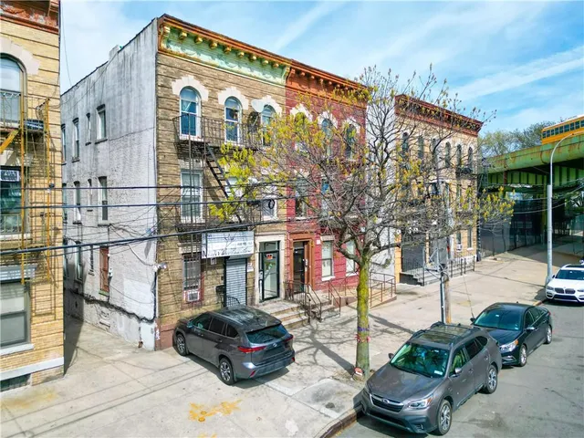 a front view of a building with parking