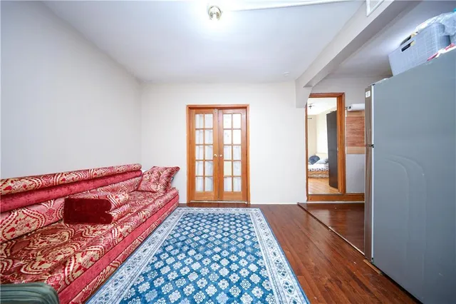 a bedroom with natural light and a bed