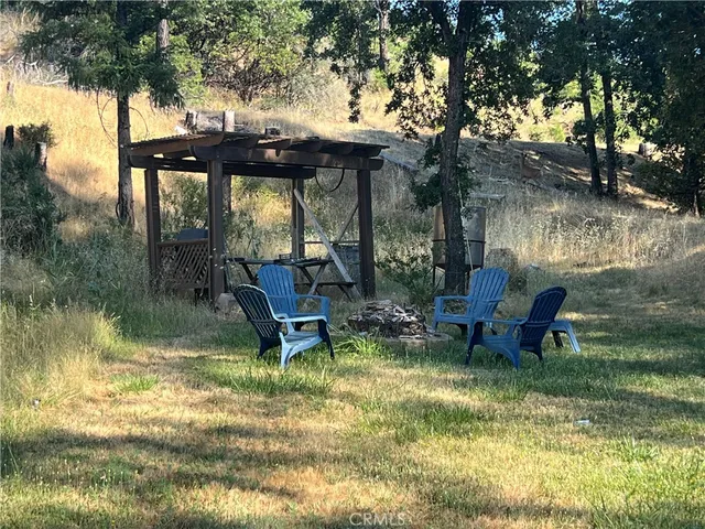 a view of swimming pool with outdoor seating and trees