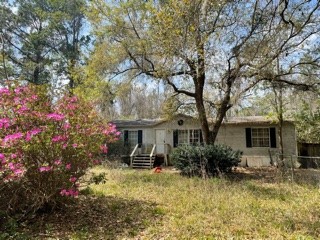 96761 Blackrock Road Yulee, FL 32097 - Photo 3 of 7 a front view of house with yard and trees around